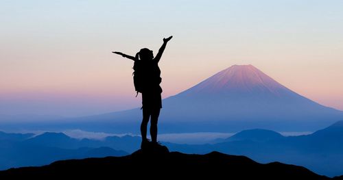 A person standing on a mountain top