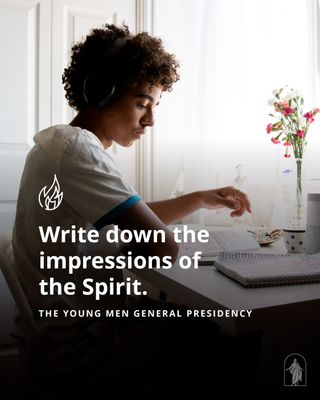 A young man sits at a desk. He has headphones on and is studying the scriptures.