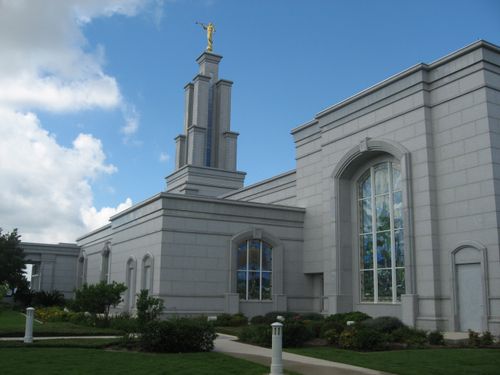 A side view of the San Antonio Texas Temple, with a view of windows and the spire and a partial view of the grounds.