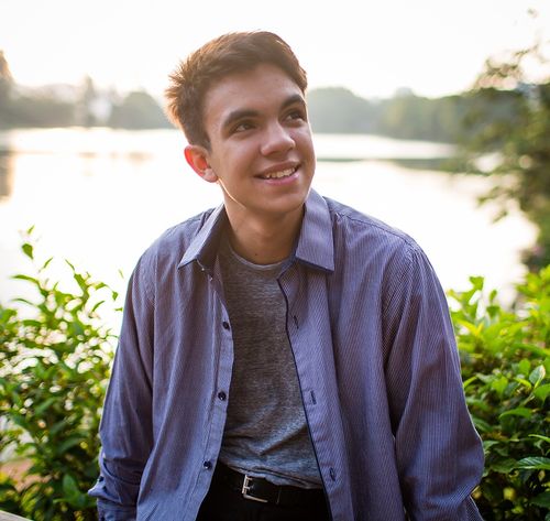 man smiling by lake