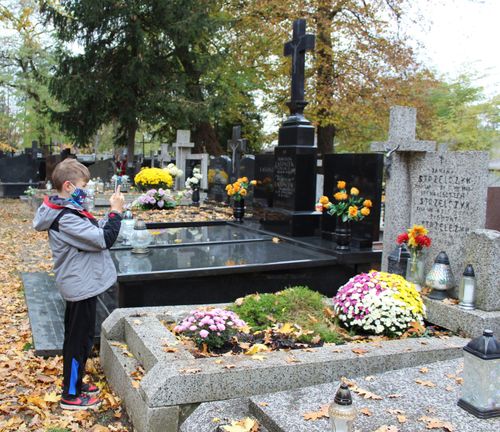 boy taking pictures at cemetery