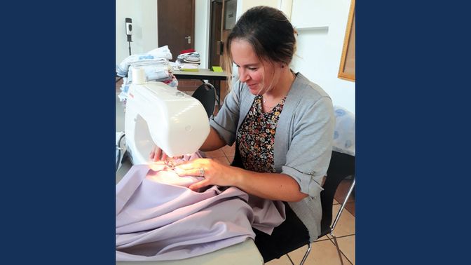 A women using a sewing machine.