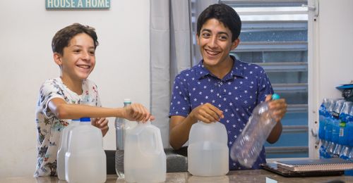 young men and water bottles