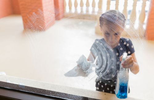 child cleaning window