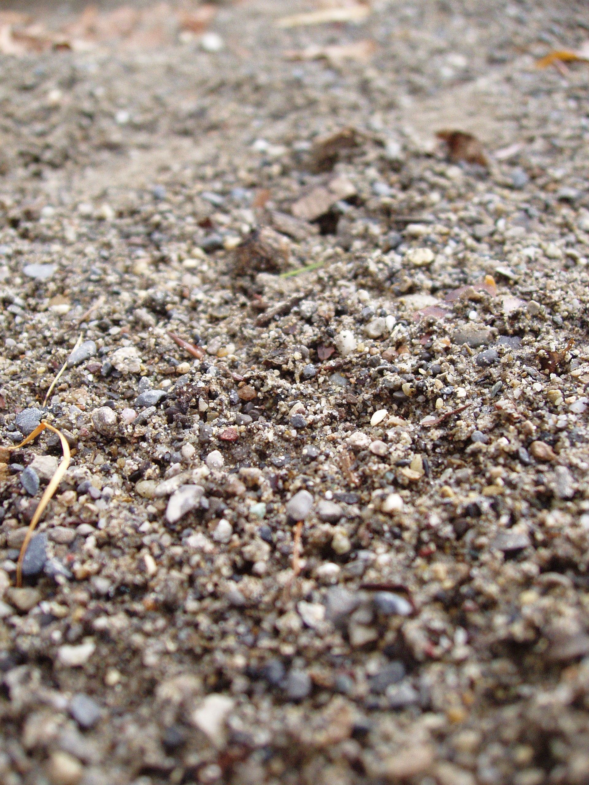 A patch of gravel on a dirt road.