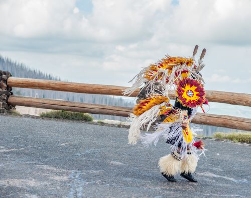 Native American man dancing in ceremonial dress