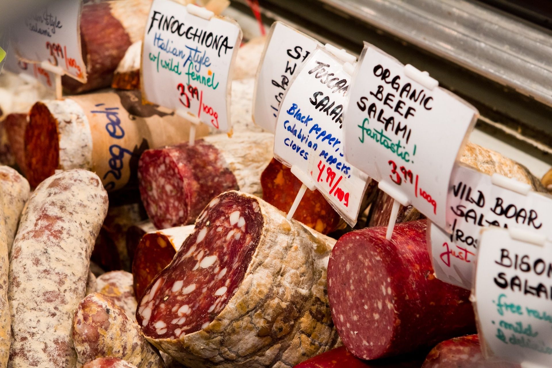 Different types of salami at a supermarket.