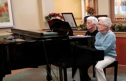 photo of Irene and Alice playing a piano duet