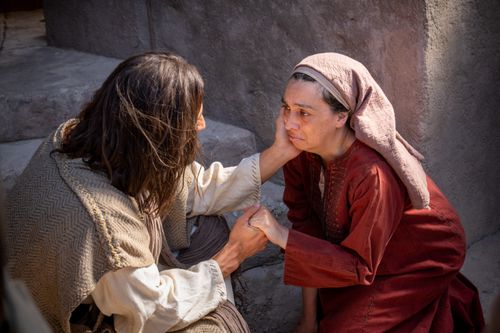 Jesus heals a woman with an issue of blood.