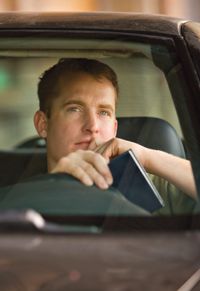 man behind steering wheel