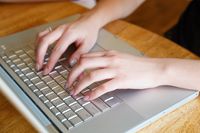 youth typing on computer