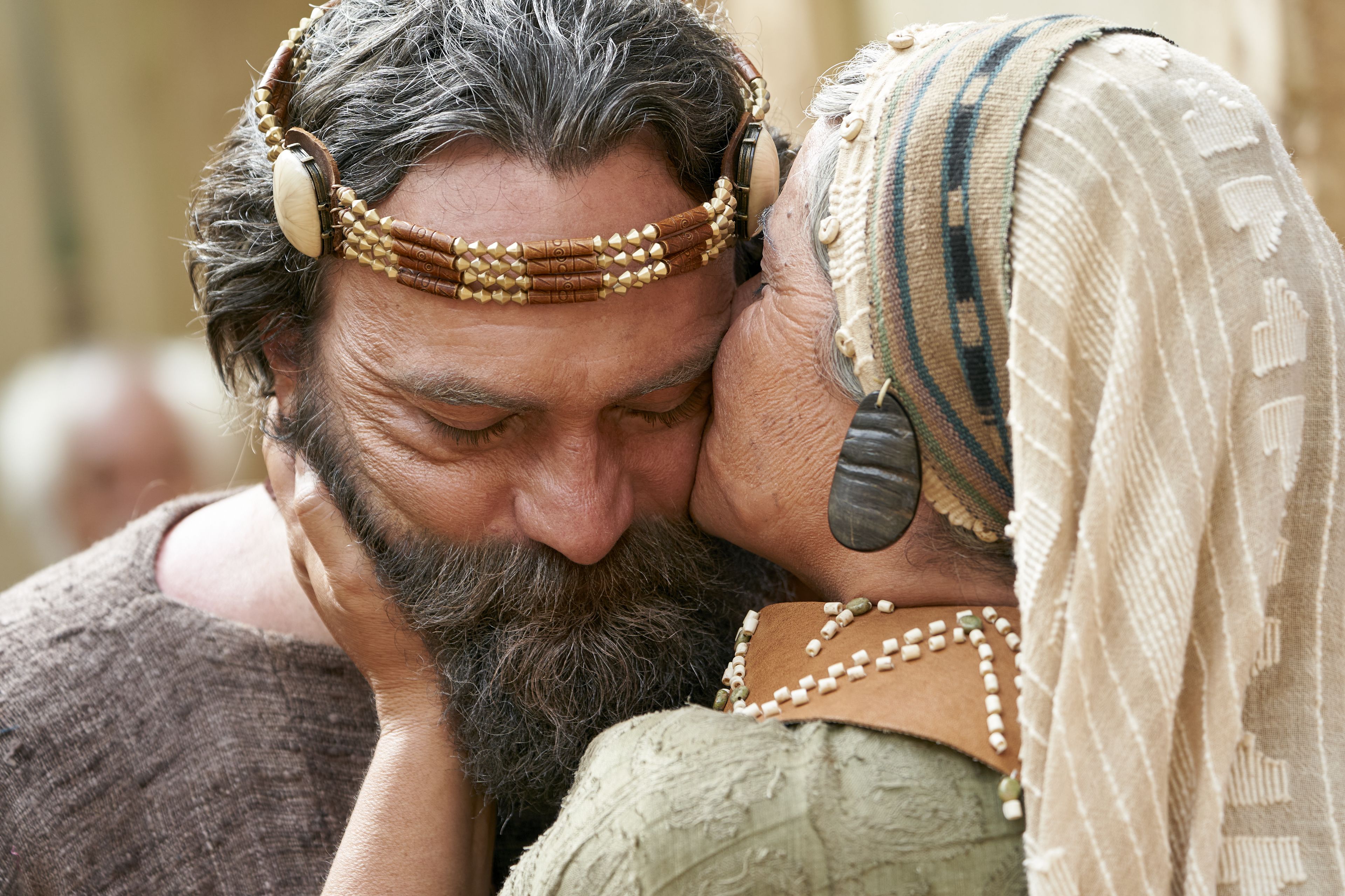 King Benjamin's wife gives King Benjamin a kiss on the cheek before he goes to speak to the Nephites in the Land of Zarahemla.