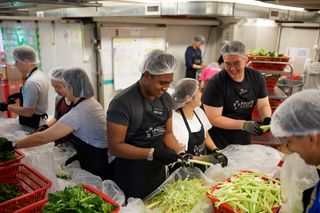 Missionaries helping distribute food during a service project in Hong Kong.