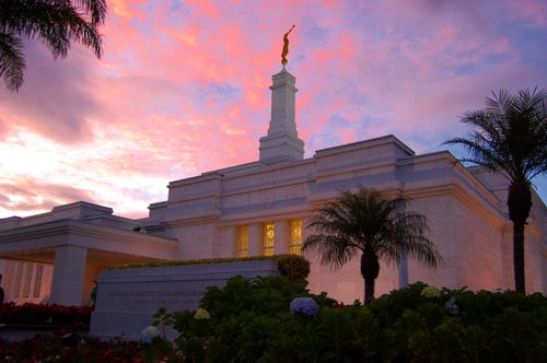 The San José Costa Rica Temple in the late evening, with a partial view of the entrance, the temple name sign, and the grounds.