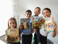 children holding copies of the Friend in Dutch