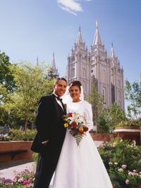 bride and groom with temple in background