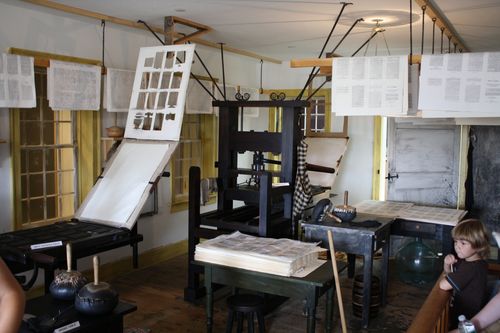 A room full of printing press equipment and papers in Palmyra, New York.
