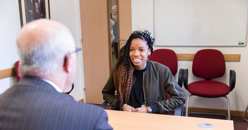 A young woman meets with her Bishop.