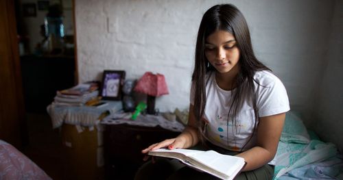 A young woman studying the scriptures.