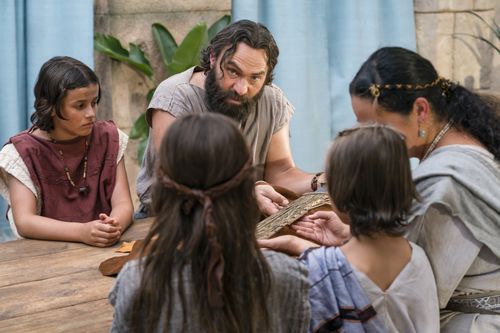 King Benjamin gathers with his family around a table in the Land of Zarahemla and tells them he can no longer be king.