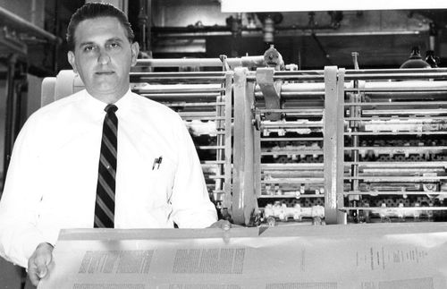 Thomas S. Monson standing near printing press