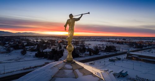 Angel Moroni on the Meridian Idaho Temple during winter at sunrise.