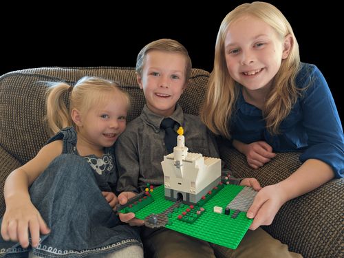 Austin Bullock with his sisters and a lego temple.