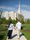 couple walking toward Oquirrh Mountain Utah Temple