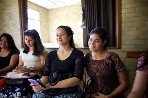 A row of women sitting in a meeting at church in Paraguay.