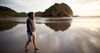 young man walking on beach