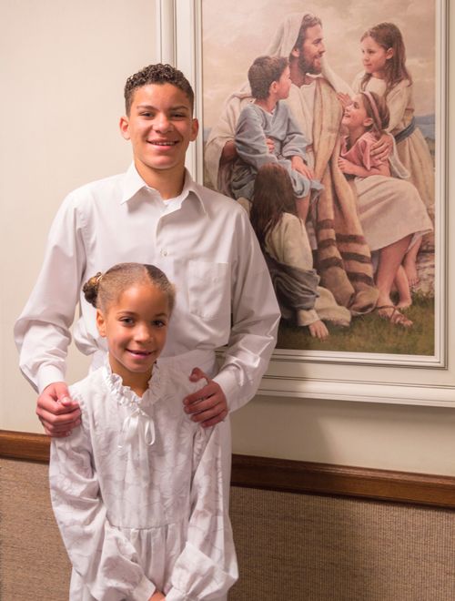 sister and brother in white clothes for baptism