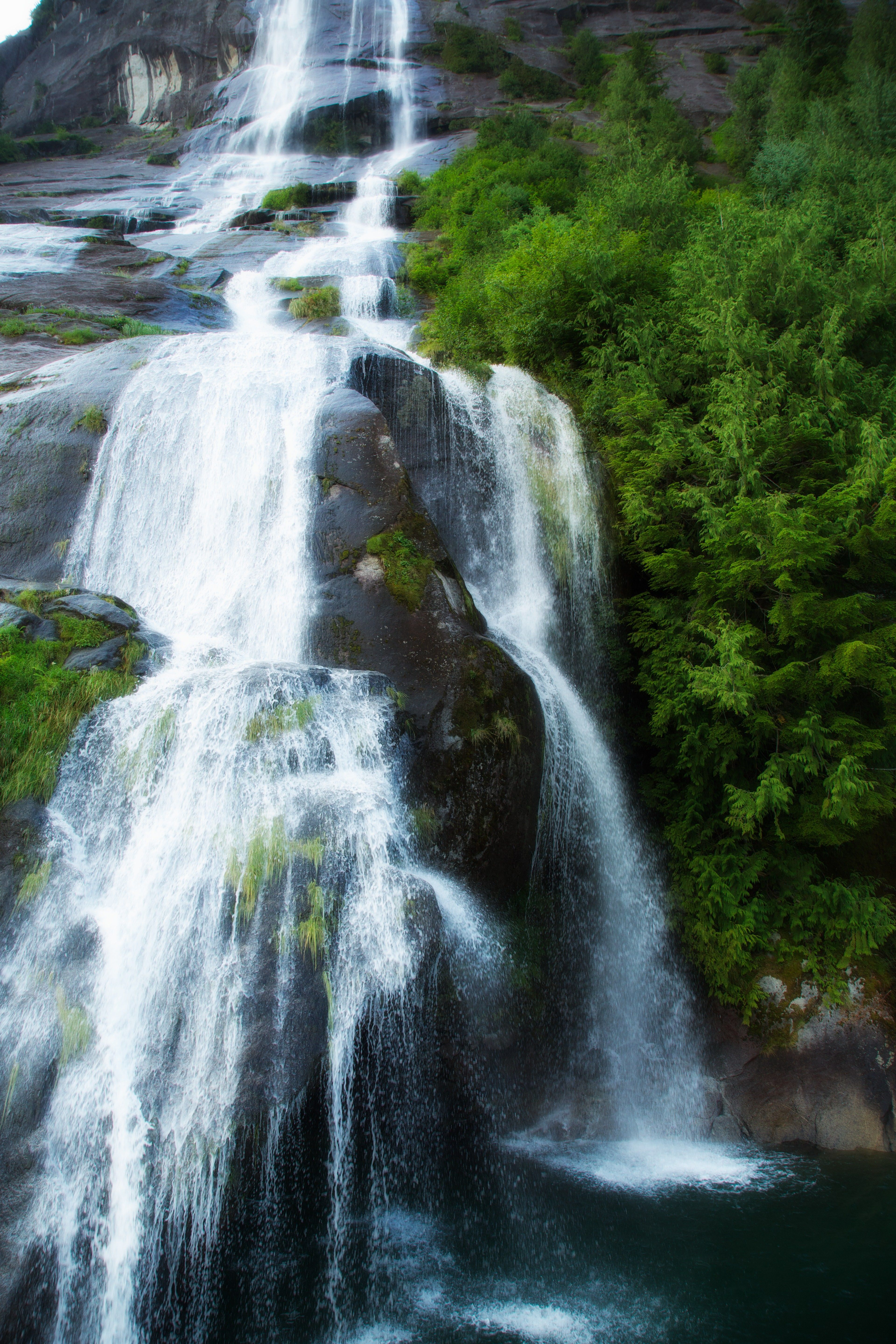 A waterfall runs into a pool in Alaska.