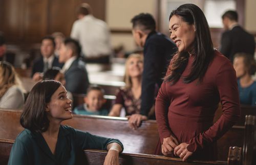 two women greeting each other at church