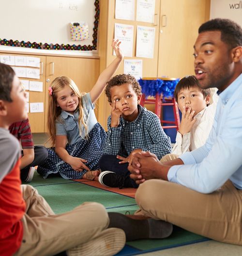 man teaching young students