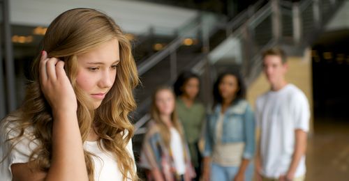 young woman apart from group