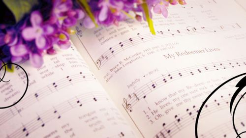 Cover art for the Music with A Message audio series. Flowers on top of an open hymnbook. Opened to the hymn, My Redeemer Lives.