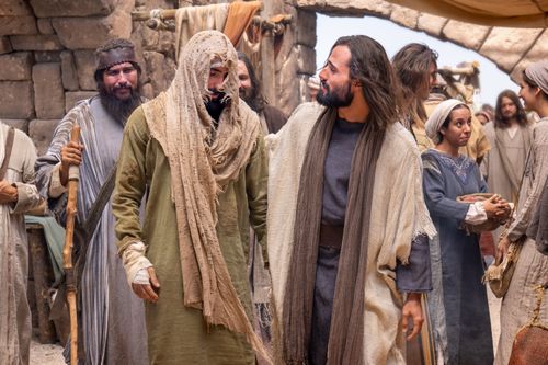 Jesus Christ and a leper walk together in Jerusalem.