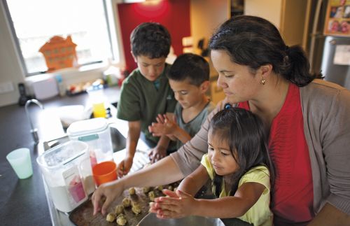 Mother and children making cookies.