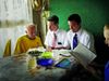 Missionaries teaching an older man