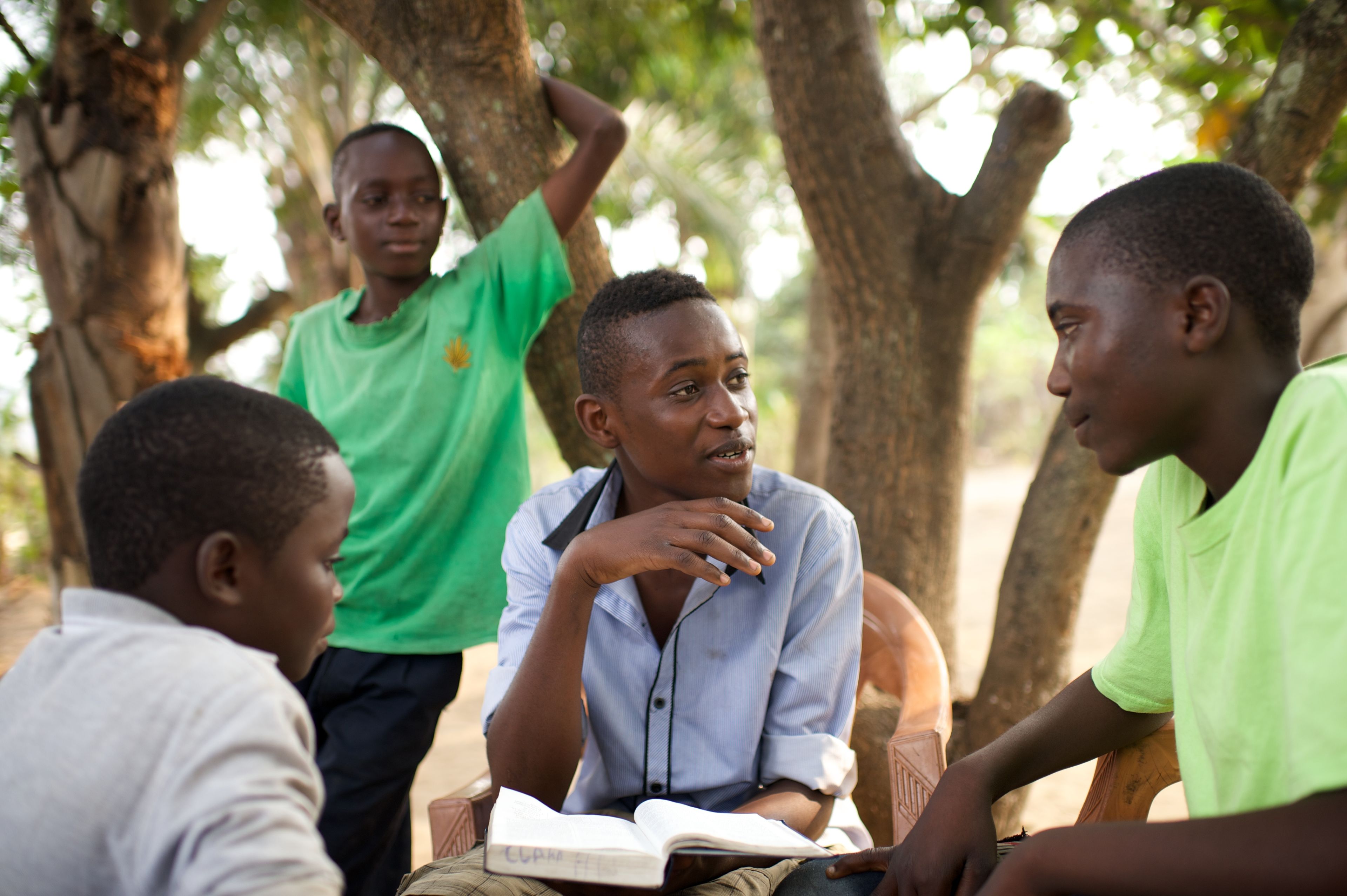 A group of young men studying the scriptures together.