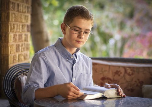 Young man reading the scriptures.