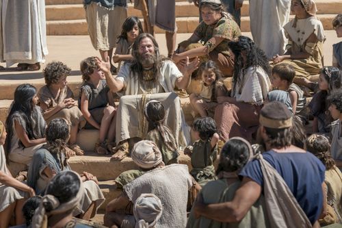 Jacob sits on the temple steps, surrounded by the Nephites as he teaches them.