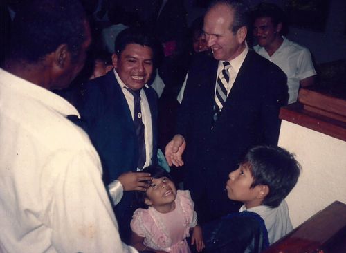 President Russell M. Nelson standing with Church members