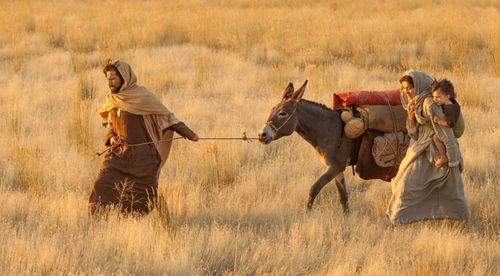 Joseph leading a donkey by a rope, Mary is walking along the side of the donkey holding a young Jesus on their way to Egypt. Outtakes include Mary walking with Jesus ahead of Joseph as well as Mary walking behind