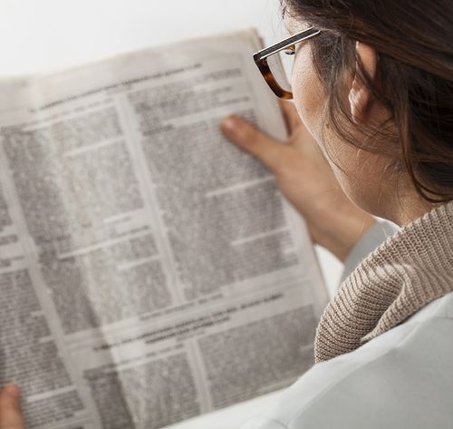 woman reading newspaper