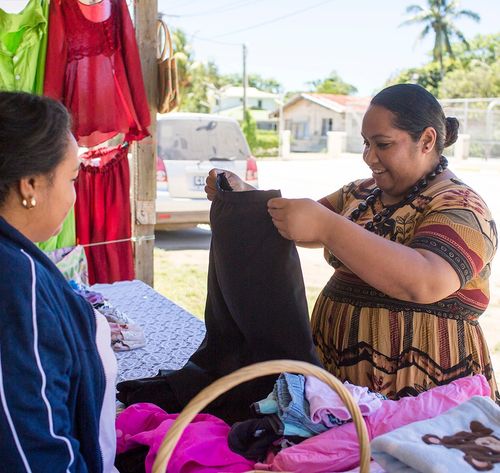 woman selling clothes to customer