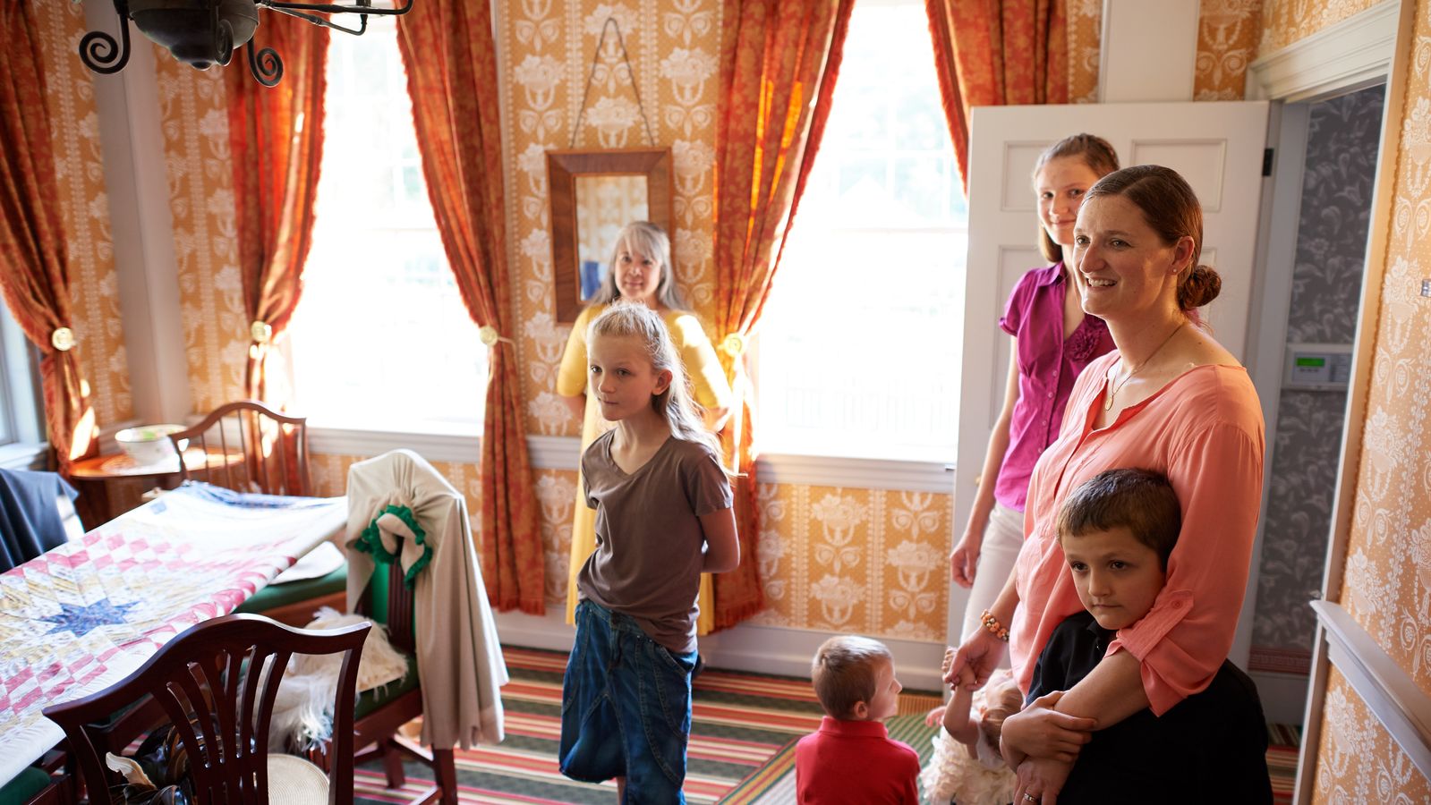 Various people interact with exhibits in Historic Sites found in New York and Pennsylvania. They appear to be in homes.