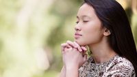 An Asian girl praying