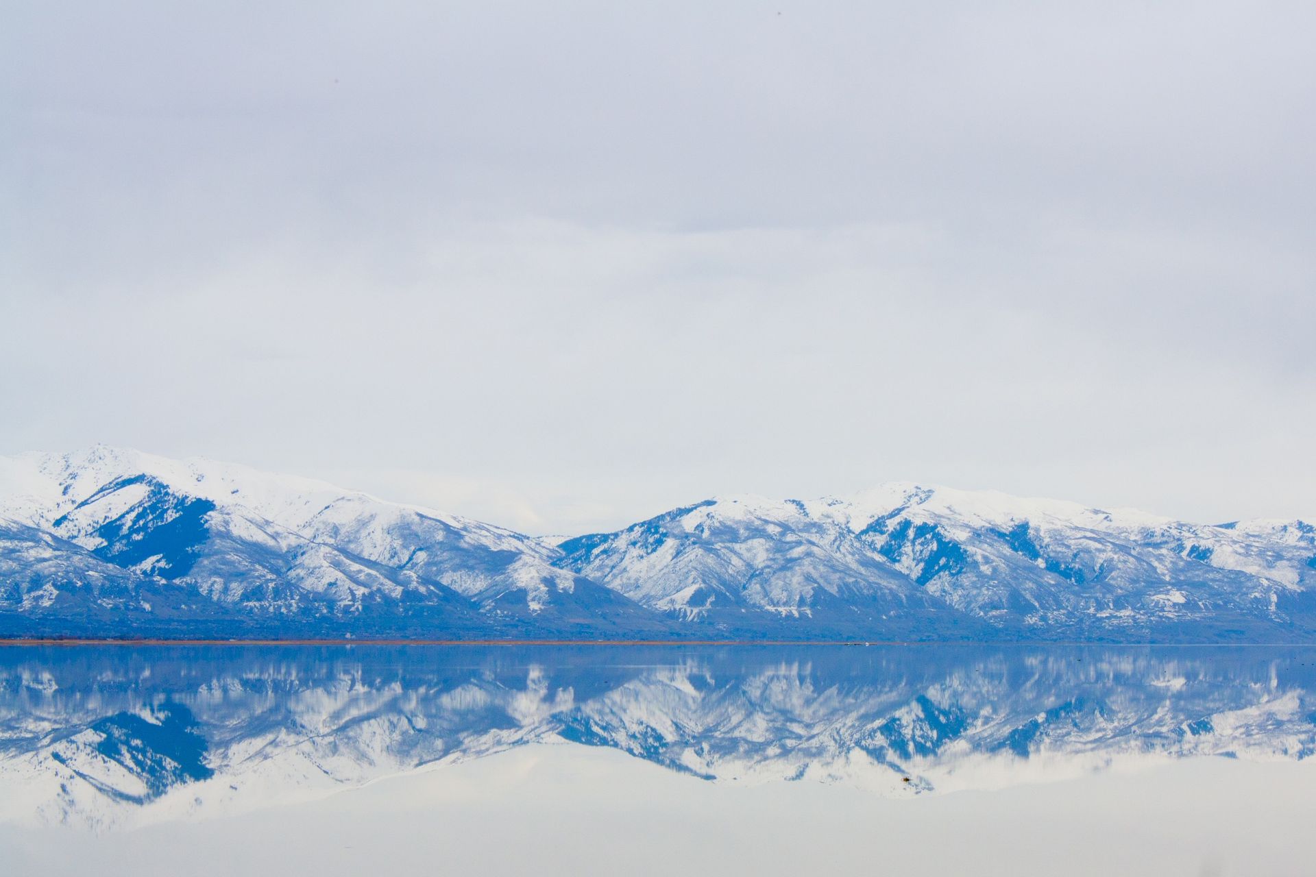 A view of the Great Salt Lake, with snow-covered mountains in the background.