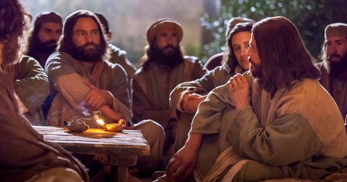 Jesus sitting at a table teaching.